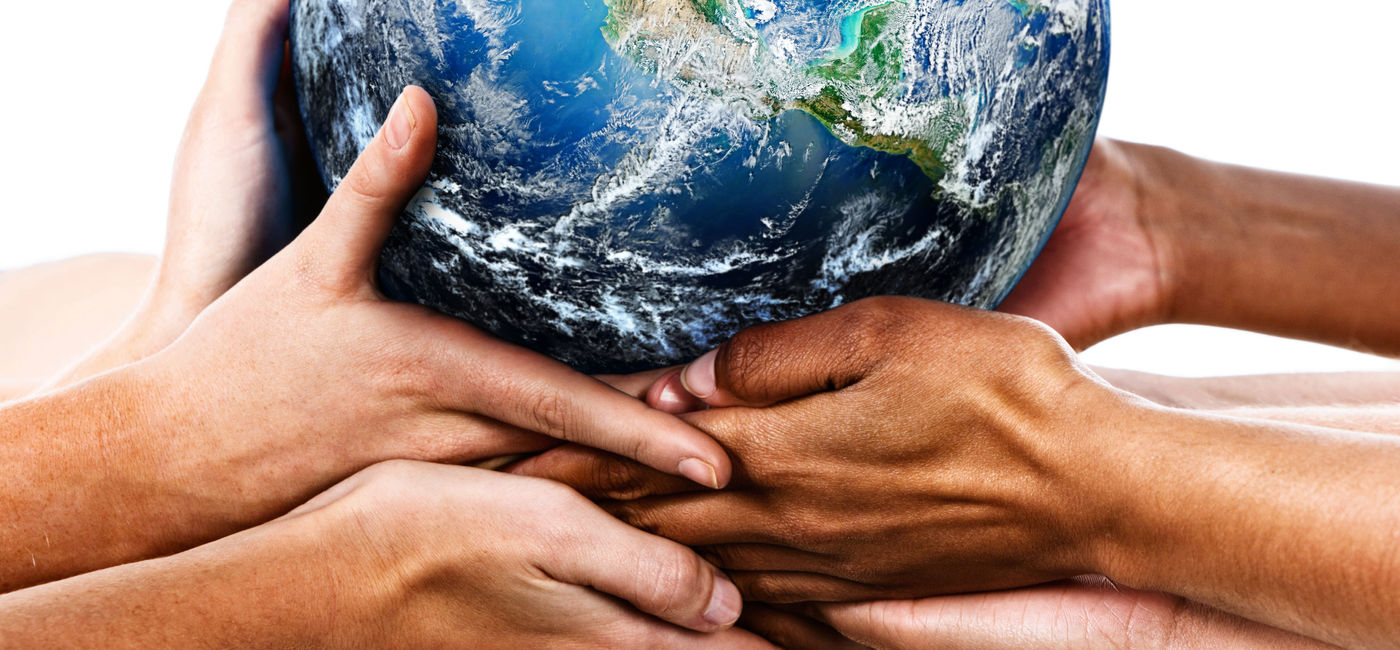 Image: Diverse hands holding the Earth (Photo Credit: RapidEye / Getty Images)