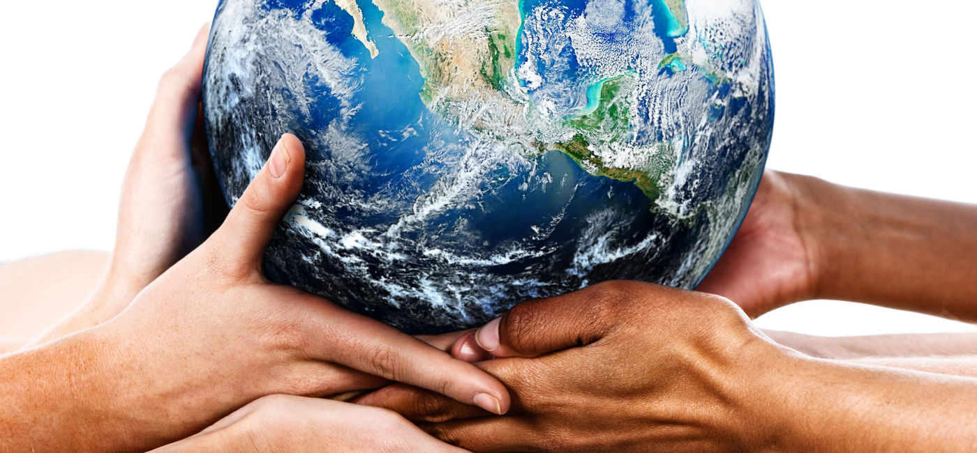 Image: Diverse hands holding the Earth (Photo Credit: RapidEye / Getty Images)