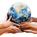 Diverse hands holding the Earth