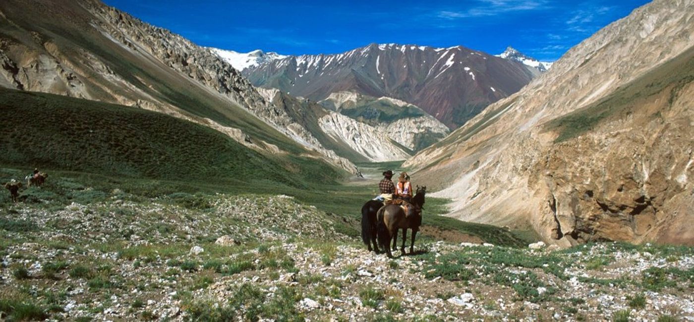 Image: A couple rides horses in Cajon del Maipo, Chile. (photo via Chile Travel) ((photo via Chile Travel))
