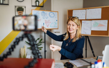Teacher communicating with pupils via videoconference.