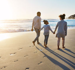 Family on the beach, sunset walk