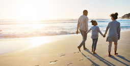 Family on the beach, sunset walk