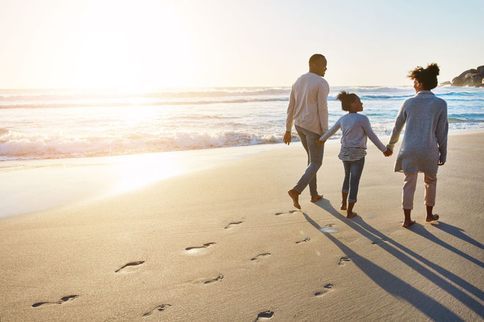 Family on the beach, sunset walk