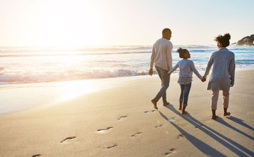 Family on the beach, sunset walk
