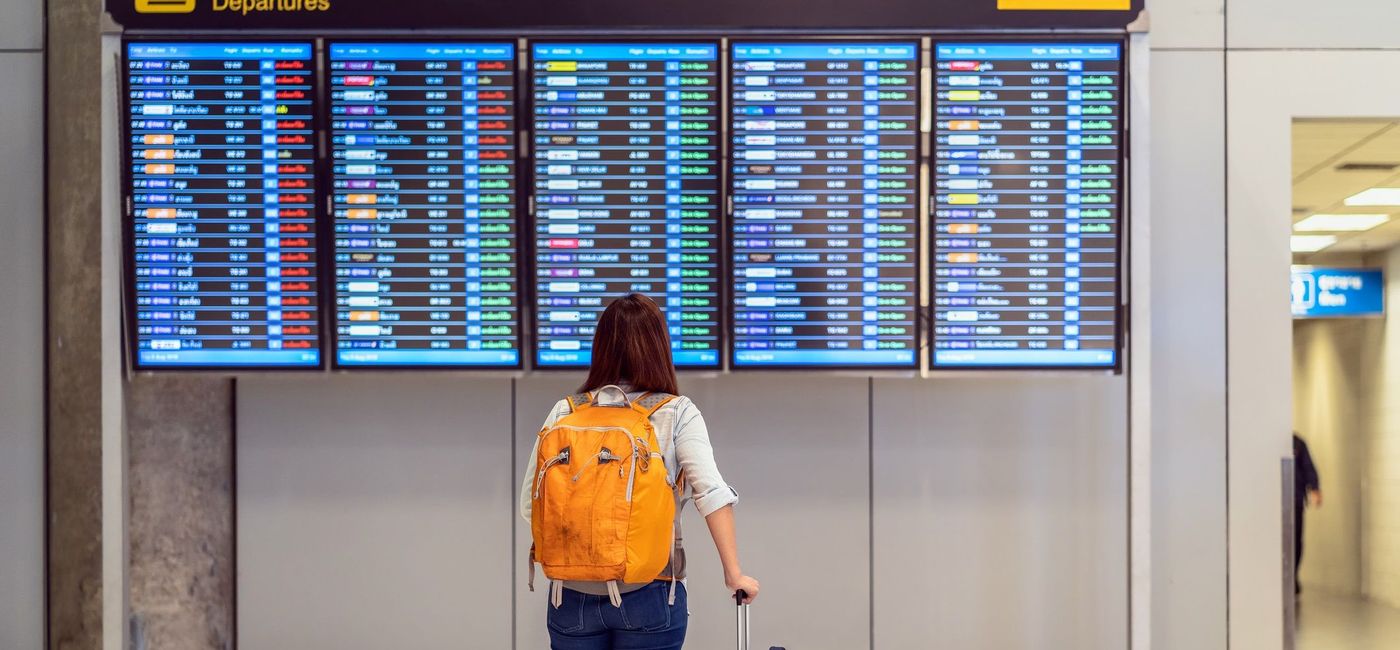 Image: Passenger checking the flight schedule. (Tzido / iStock / Getty Images Plus)