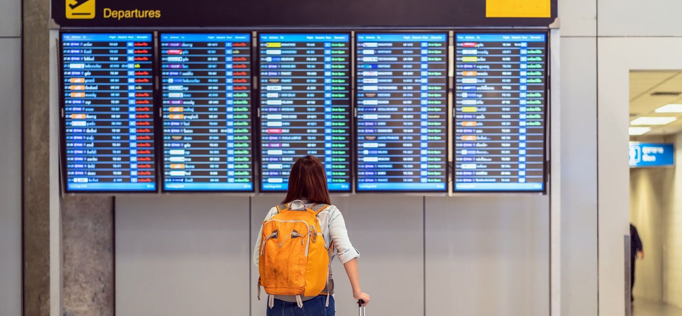 Image: Passenger checking the flight schedule. (Tzido / iStock / Getty Images Plus)