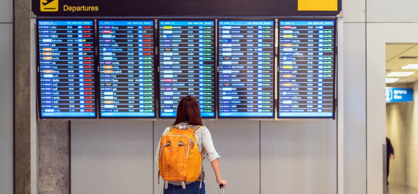 Image: Passenger checking the flight schedule. (photo via Tzido / iStock / Getty Images Plus)