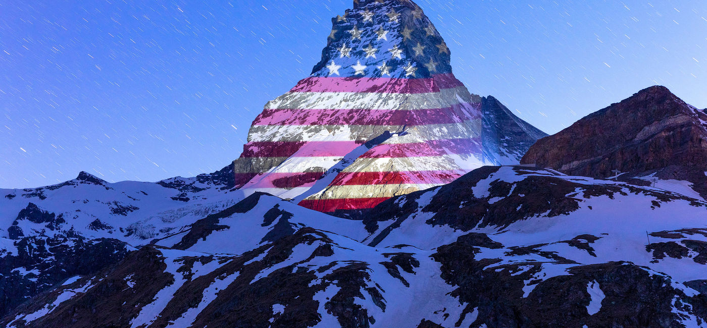Image: PHOTO: Matterhorn mountain illuminated with the American flag. (©Light Art by Gerry Hofstetter/Photo by Frank Schwarzbach) (©Light Art by Gerry Hofstetter/Photo by Frank Schwarzbach)
