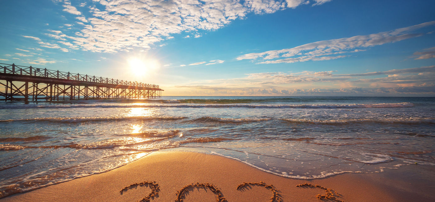 Image: '2023' inscribed on a beach with the waves and pier in the background.  (Photo Credit: iStock/Getty Images Plus/valio84sl)