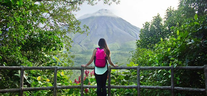 Hiker looking out at the Arenal volcano in La Fortuna