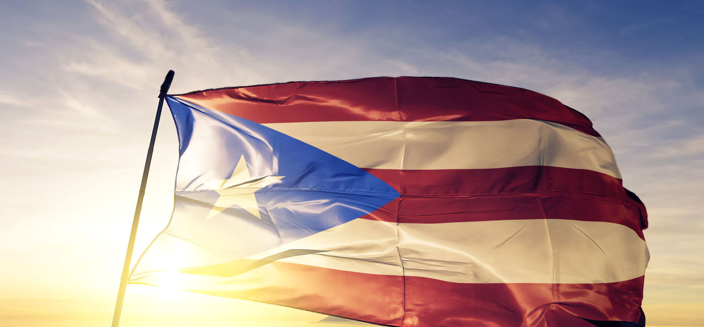 Image: Puerto Rico's flag at sunset. (photo via iStock/Getty Images Plus/Oleksii Liskonih)