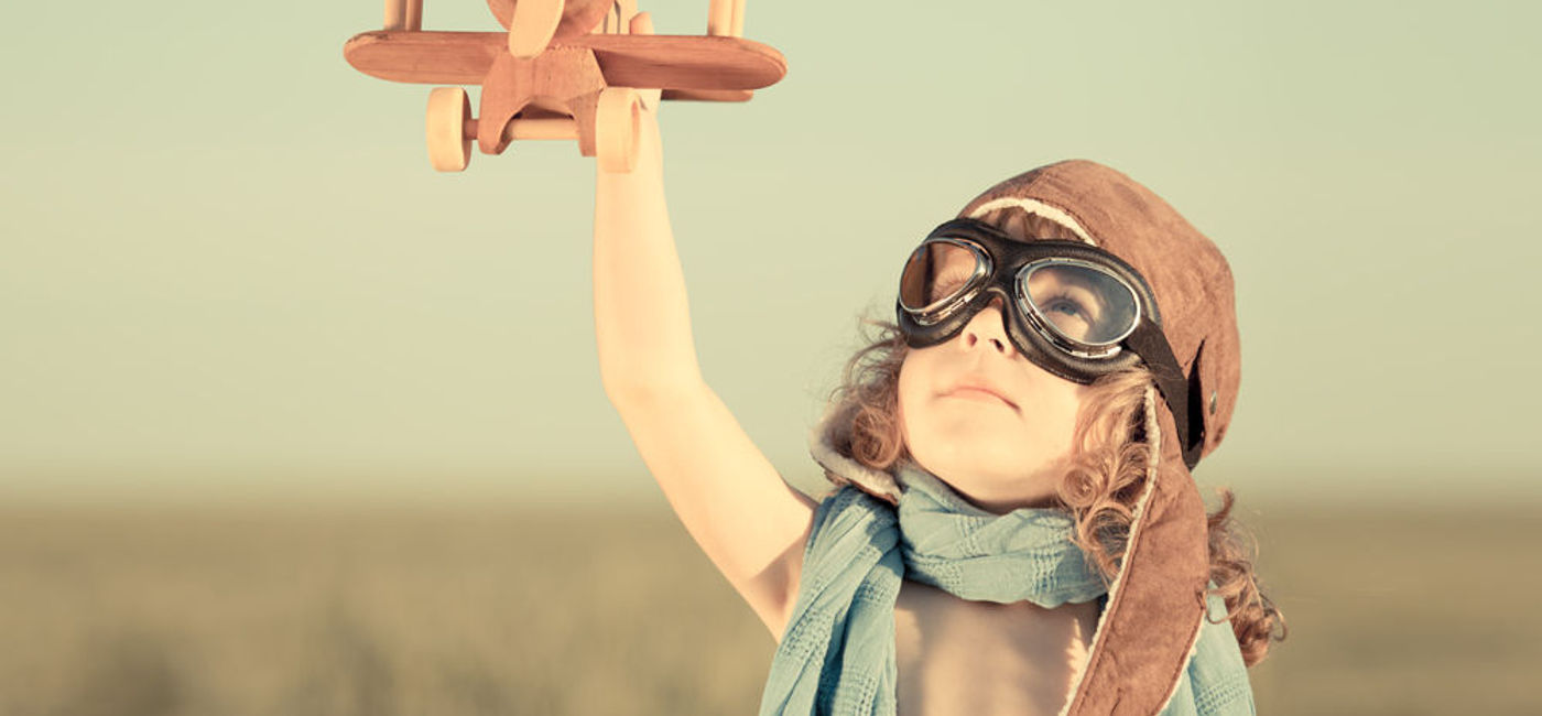Image: PHOTO: Small boy with wooden airplane. (photo courtesy of Thinkstock)