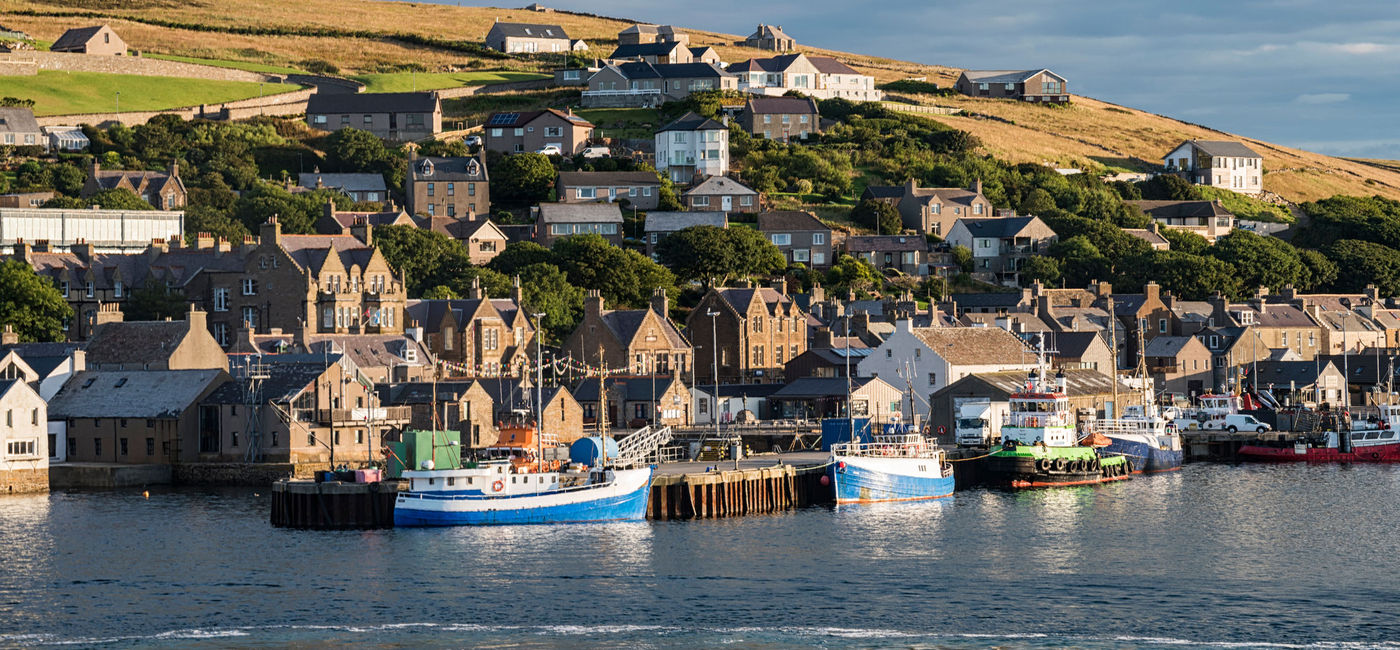 Image: The village of Stromness as seen from the sea.  (Photo Credit: Nicola Colombo / iStock / Getty Images Plus)