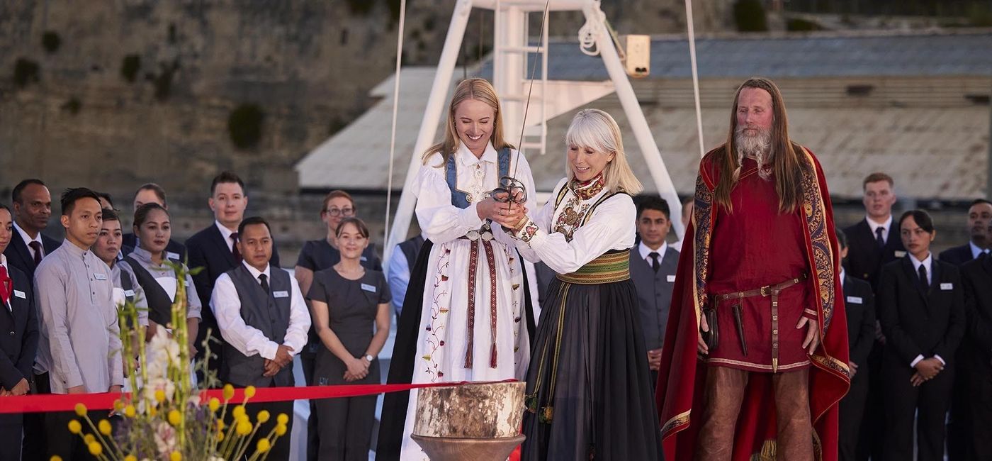 Image: During the naming ceremony of the Viking Mars, Charlotte of Highclere Castle (left) and Karine of Viking (right), use a replica of De Valette’s battle sword to cut a ribbon allowing a bottle of Norwegian aquavit to smash on the ship’s hull, in keeping with maritime tradition. (photo via Viking Cruises) ((photo via Viking Cruises))