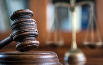 Judge's mallet and the scales of justice.