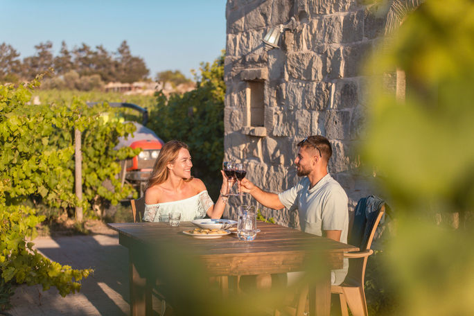 A couple enjoys wine at a Maltese winery. A couple enjoys wine at a Maltese winery.