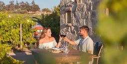 A couple enjoys wine at a Maltese winery. 