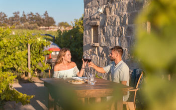 A couple enjoys wine at a Maltese winery. 