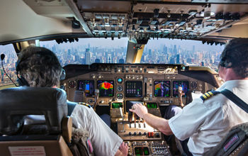 Commercial passenger aircraft pilots in the cockpit.