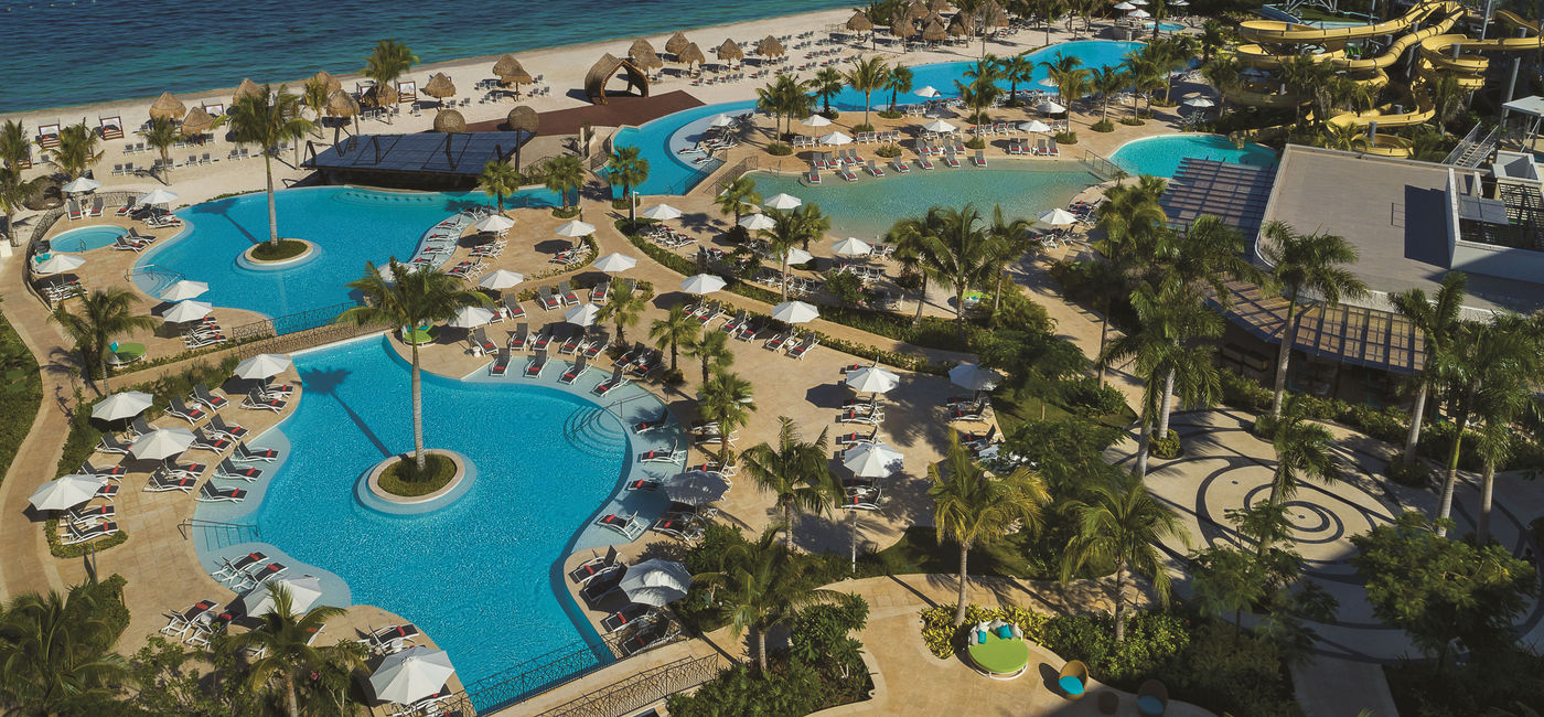 Image: Panoramic view of Dreams Natura Resort & Spa's pools and water park. (photo via Dreams Resorts & Spas)