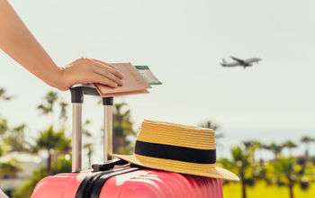 Female traveler with a suitcase at the airport