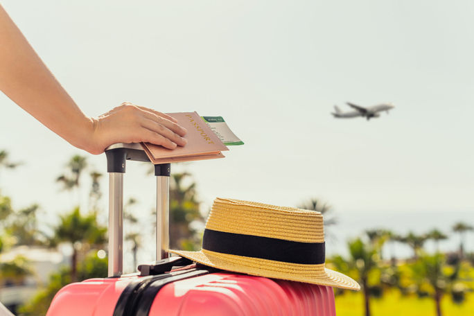 Female traveler with a suitcase at the airport