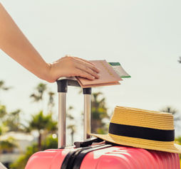 Female traveler with a suitcase at the airport