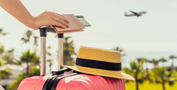 Female traveler with a suitcase at the airport