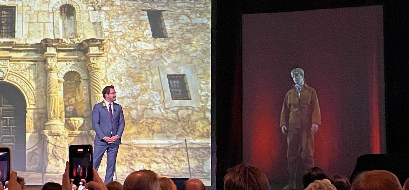 Image: Visit San Antonio CEO Marc Anderson in conversation with a holographic version of Alamo hero Davey Crockett. (Bruce Parkinson)