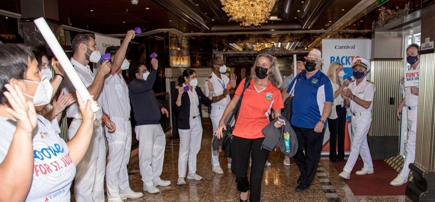 Image: Carnival Cruise Line staff welcome the first guests as Carnival Pride returns to Tampa after a long pandemic absence. (Carnival Cruise Lines)