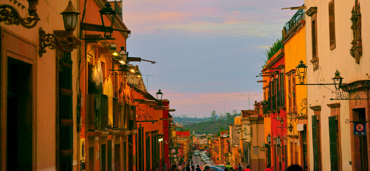 Image: Colorful exteriors of homes along a corridor in San Miguel de Allende. (Photo courtesy of iStock / Getty Images Plus / redtea)