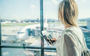 Woman awaiting her departure at an airport.