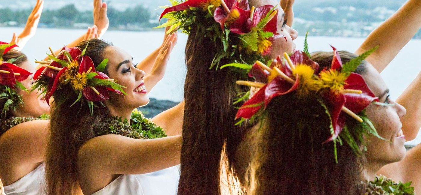 Image: Hula halau dancers dressed for a performance. (Photo via Hawaii Tourism Authority Tor Johnson)