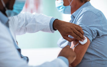 Mature man receiving a vaccination.
