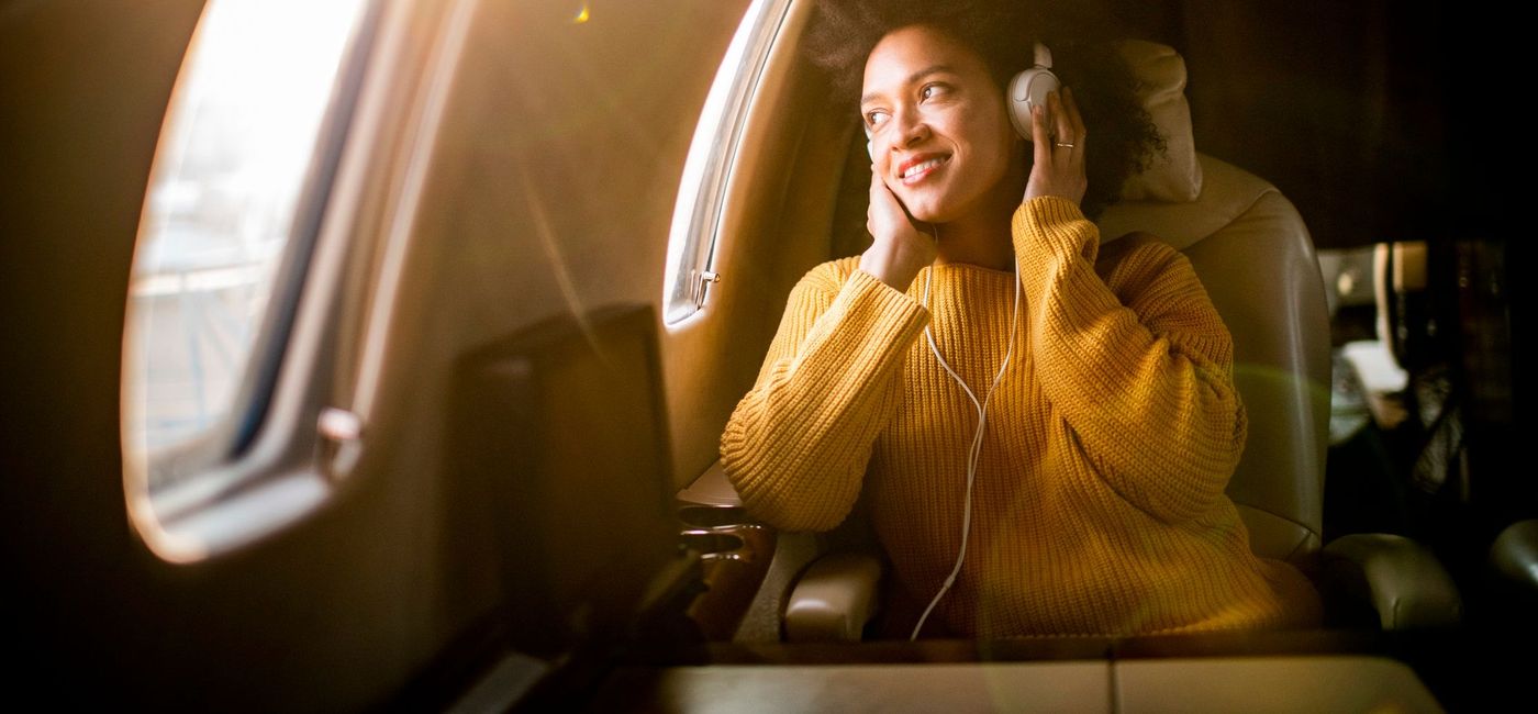 Image: Listening to music on a plane. (photo via EXTREME-PHOTOGRAPHER / getty images) (EXTREME-PHOTOGRAPHER)