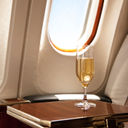 Champagne provided at a passenger&#39;s airplane seat.
