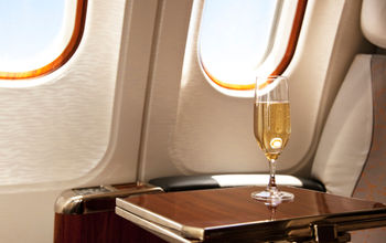 Champagne provided at a passenger&#39;s airplane seat.
