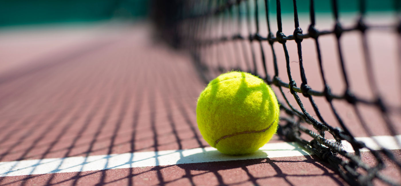 Image: Tennis ball on the court. (Photo Credit: icetocker / iStock / Getty Images Plus)