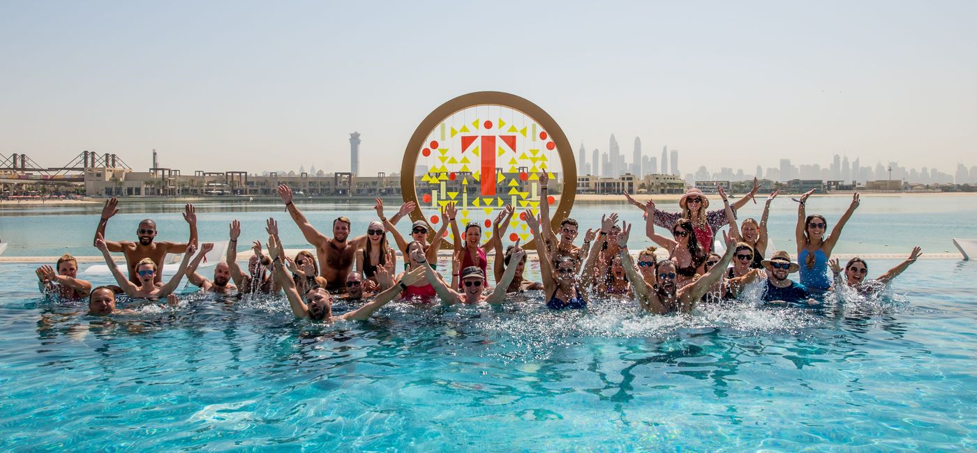 Image: Travel industry members networking in the pool in Dubai. (photo via Tammy Levent)
