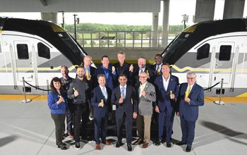 Mayors stand in front of Brightline trains in Orlando.