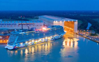 Norwegian Encore emerges from the Meyer Werft shipbuilding dock in Papenburg, Germany.