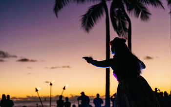Hula dancer on beach at sunset