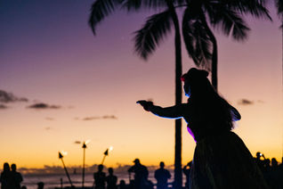 Hula dancer on beach at sunset