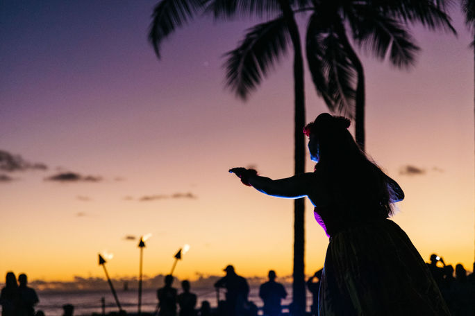 Hula dancer on beach at sunset