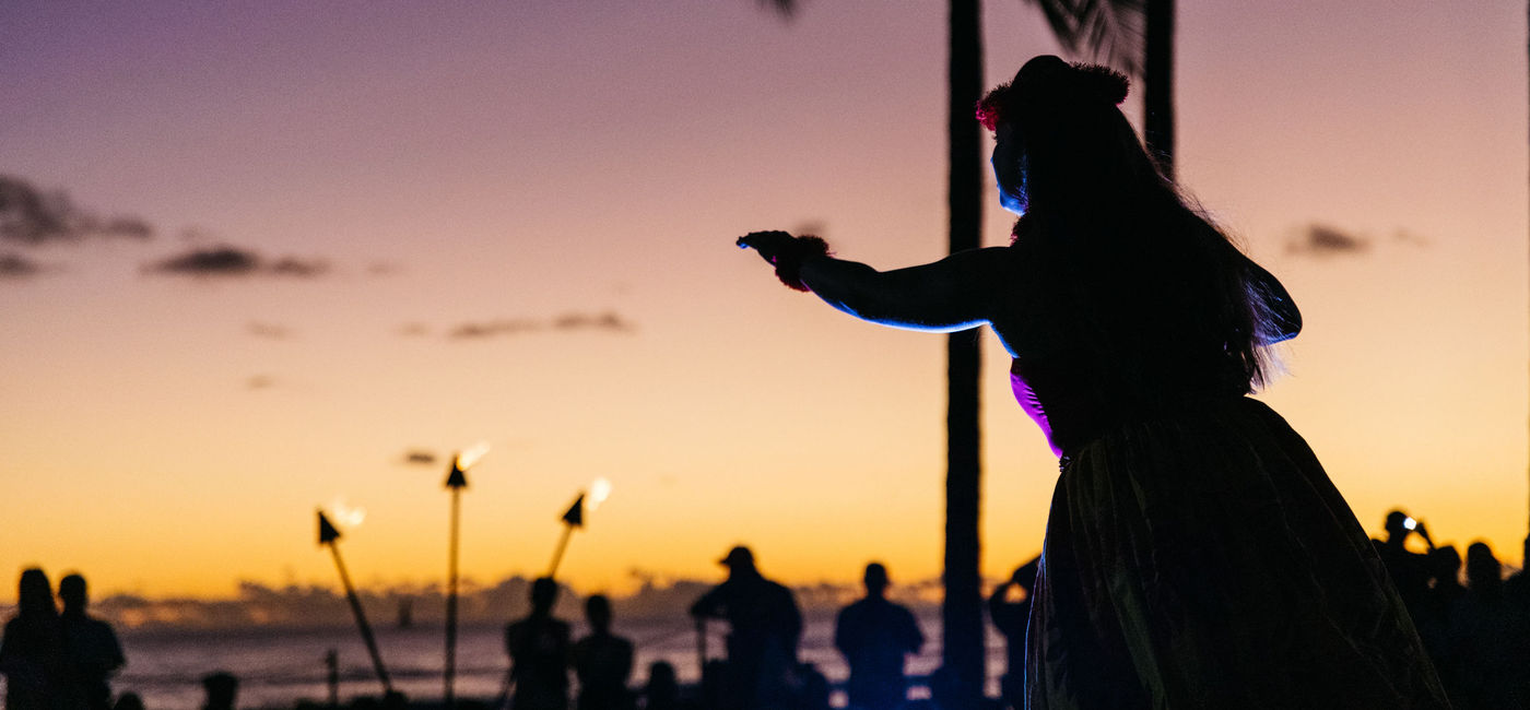 Image: A hula dancer on Waikiki Beach (Photo via Hawaii Tourism Authority)