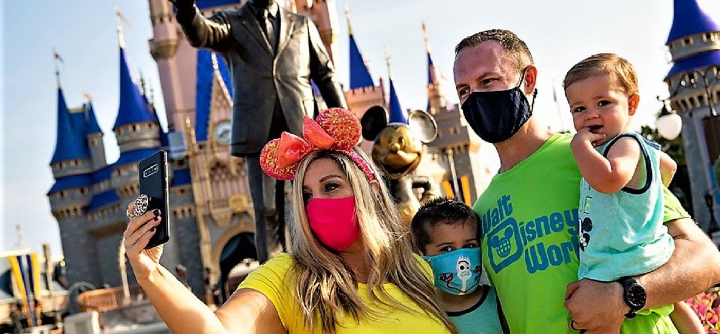 Image: A family takes a picture at the Magic Kingdom on Saturday, July 11, as Walt Disney World reopened two of its parks. (photo via Walt Disney World)