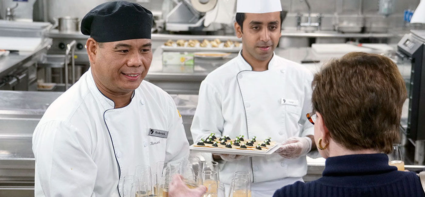 Image: PHOTO: Seabourn crew serve guests onboard Seabourn Quest. (photo by Jason Leppert)