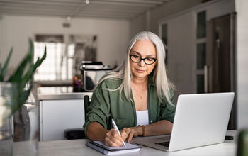 Travel advisor taking notes at home