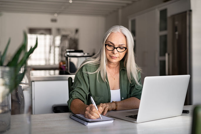 Travel advisor taking notes at home